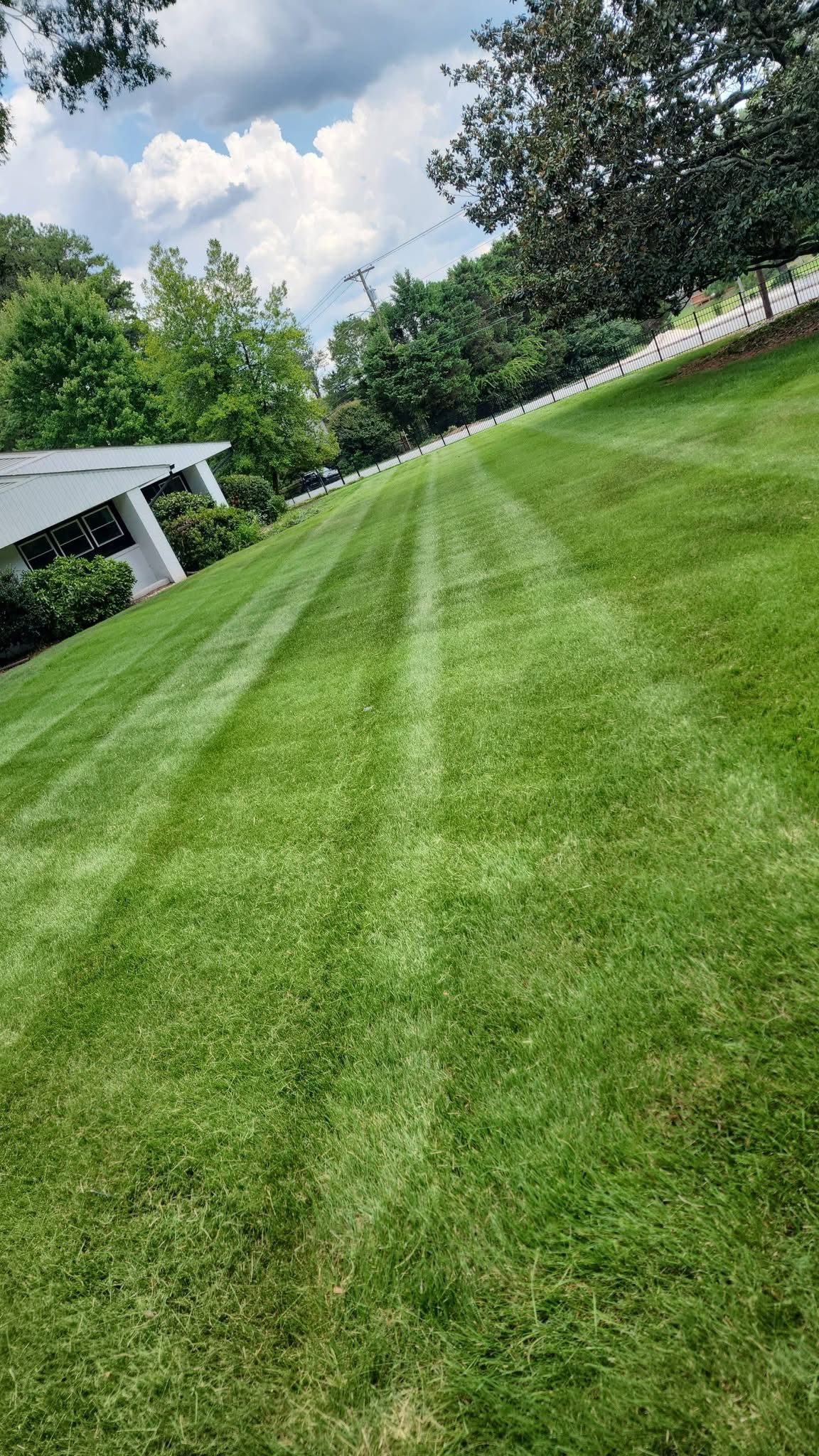 Freshly mowed large property with crisp lawn stripes